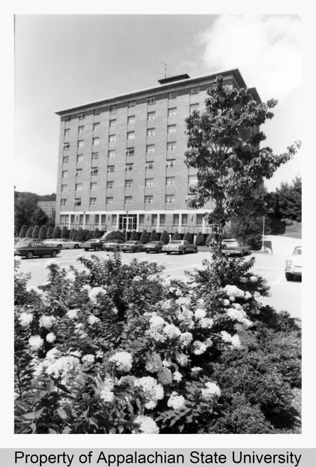 Description: This image shows the west side of Cannon Residence Hall in August 1977. Also shown are cars in the parking lot and late summer foliage in the foreground. Cannon Hall was a women's dormitory, constructed in 1968, and was part of the Eastridge Community, which also includes Lovill, White, Doughton, and Hoey Halls. It later became a co-educational dormitory. (https://omeka.library.appstate.edu/items/show/7351)