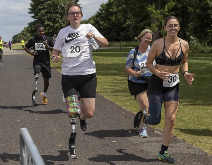 Helena and 3 other runners take part in Run with Rich 2022. Helena and two of the runners are using prosthetic running blades