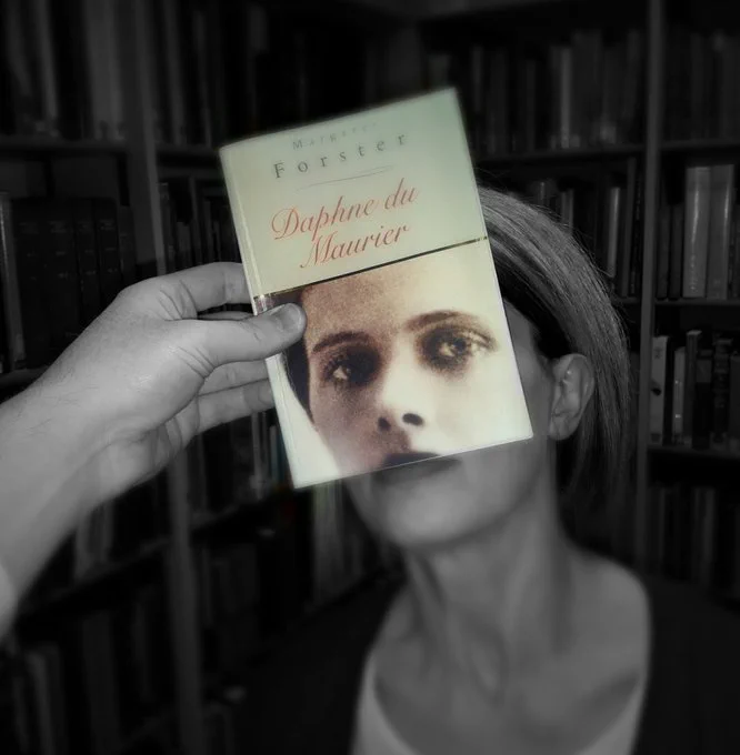 A bookface photograph with a copy of Daphne Du Maurier by Margaret Foster lined up with a member of library staff