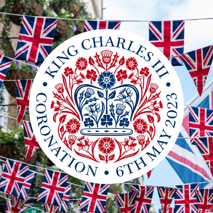 Union Flag bunting background with the Coronation emblem. Reads: King Charles III, Coronation, 6th May 2023