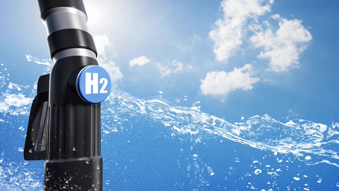 Picture of a Hydrogen Fuel Pump against a backdrop of blue skies, clouds, and water 