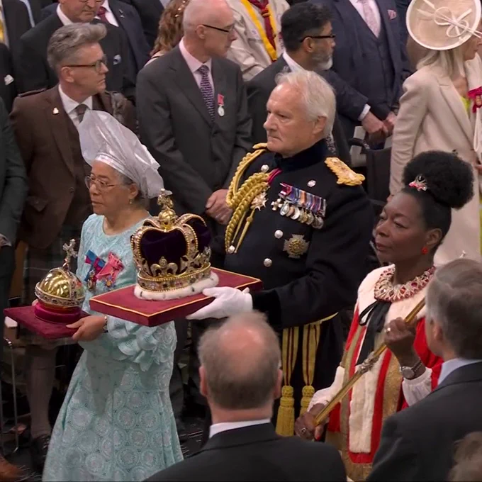 Professor Dame Elizabeth Anionwu carries the gold Sovereign Orb in the Coronation Ceremony at Westminster Abbey.
