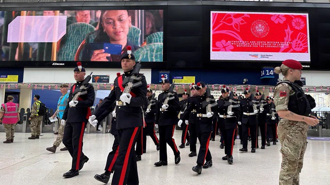 Soldiers march across the concourse at London Waterloo.