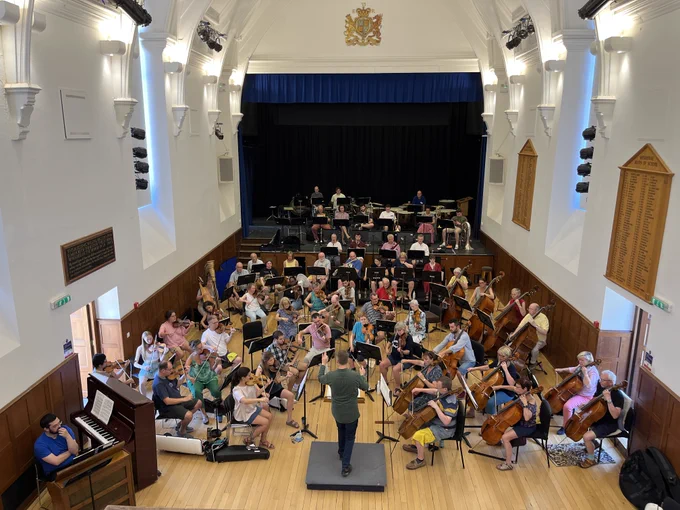 Sherborne Summer School Symphony Orchestra rehearsing with Philip Ellis conducting.