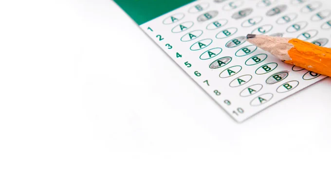 Multiple choice test answer sheet with a chewed pencil