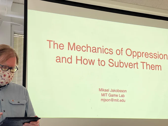 Mikael Jakobsson next to first slide of talk “The Mechanics of Oppression and How to Subvert Them”