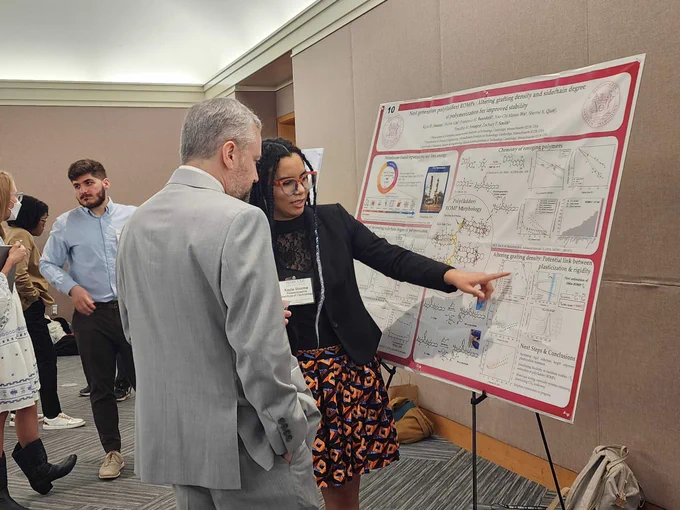 Kayla Storme presenting a poster on her PhD research during the poster session at the Charter II Collaborative Meeting.