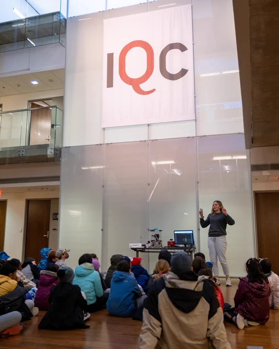 Lauren Brown, IQC’s Outreach and Education Research Assistant, leads a demonstration of ion trapping for an elementary school class visiting the Institute for Quantum Computing.
