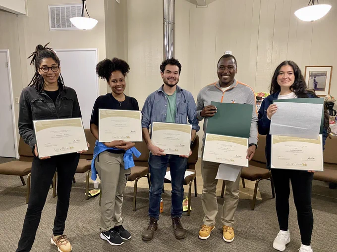 2021 smith fellows cohort - 5 people stand with diplomas