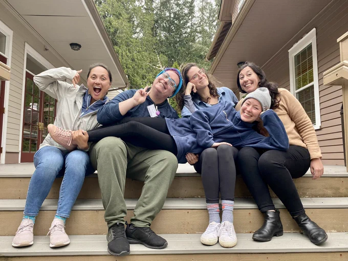 2022 smith fellows cohort - 5 people sit on stairs