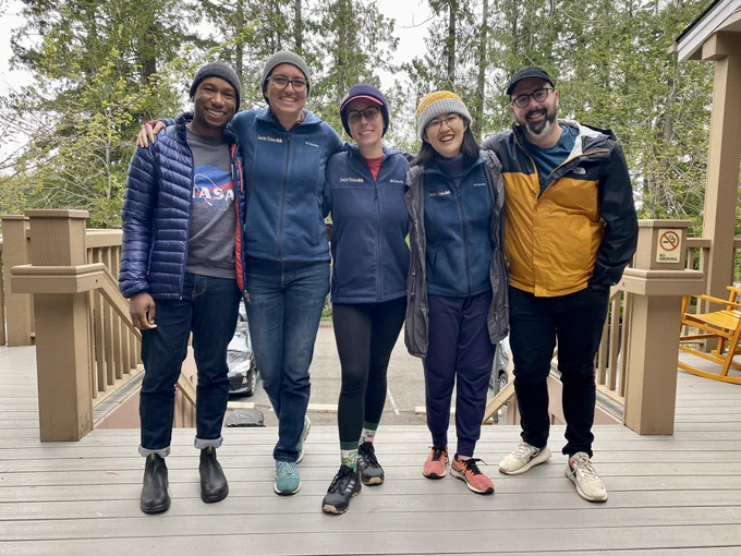 2023 smith fellows cohort - 5 people standing on a deck