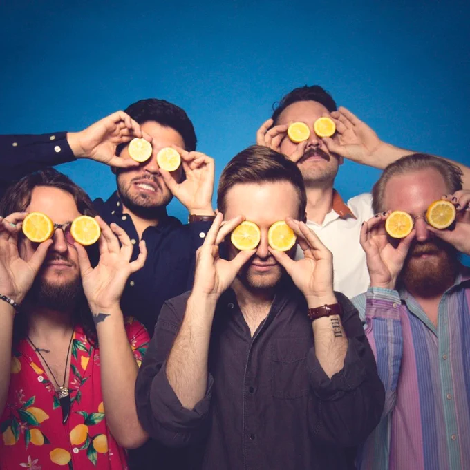 Sour Magic members holding lemons on their eyes