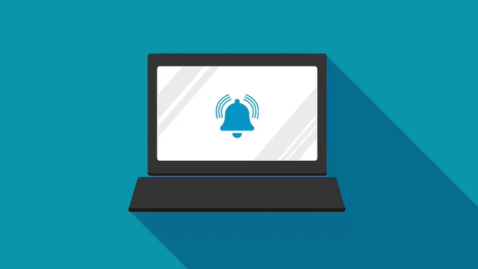 A computer is shown at the center of the image. A bell icon is displayed in the middle of the screen to represent a notification. 
