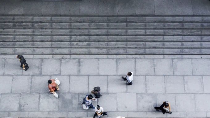 Aerial view of people walking on city sidewalk. 