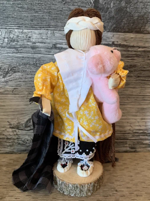 A figure dressed in traditional Indigenous clothing.