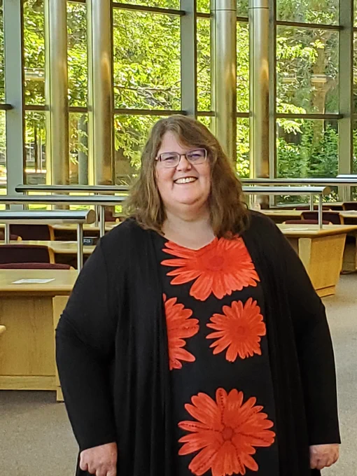 Director Dean stand in the library's atrium