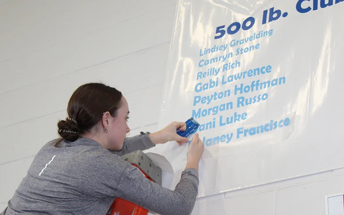 girl adding her name to a poster