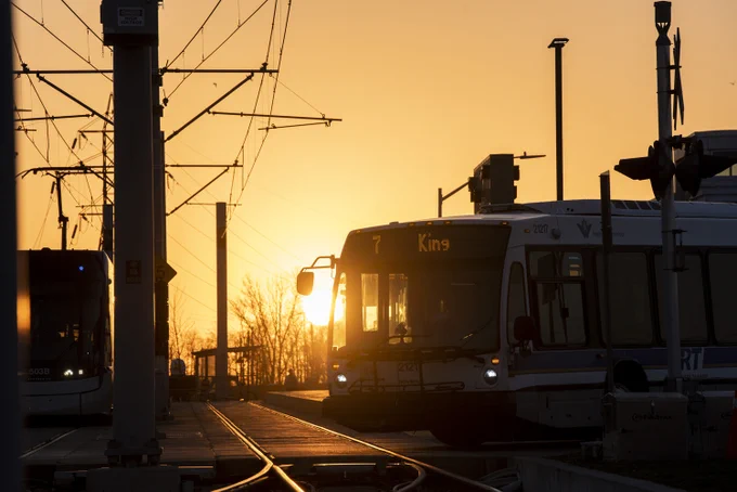 Route 7 bus at Fairway Station silhouetted against the early morning sun