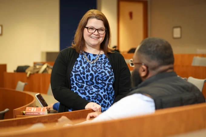 Photo of faculty member speaking with student