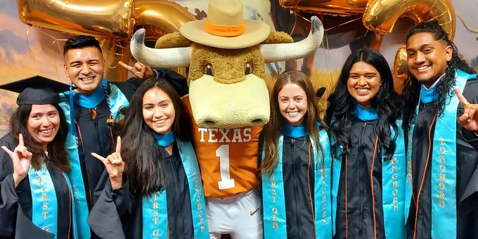 Image of six First-Gen graduates smiling for the camera with UT's Bevo mascot