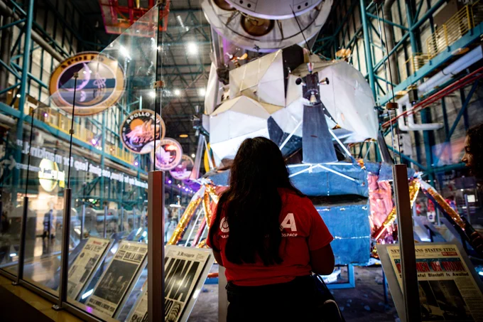 A student looks on at a model of a spacecraft at the Kennedy Space Center in Florida.
