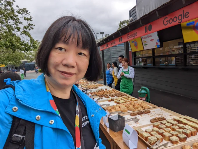 Person is pictured in front of the Google I/O Shoreline pastries table.