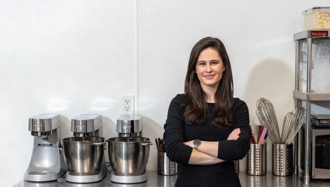 Ilona Znakharchuk standing with arms crossed in a kitchen