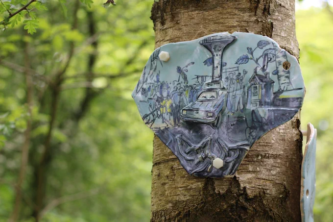 A tree with a ceramic plate attached depicting the scene of a strike