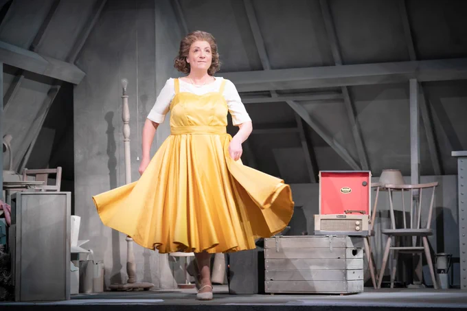 A Person swishing a yellow dress they are wearing
