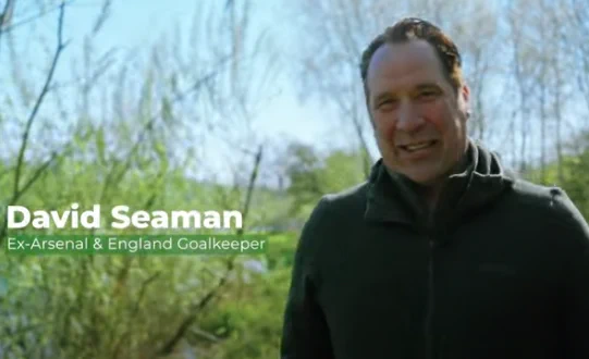 A man walking in the outdoors, with a caption which reads 'David Seaman, Ex-Arsenal and England goalkeeper