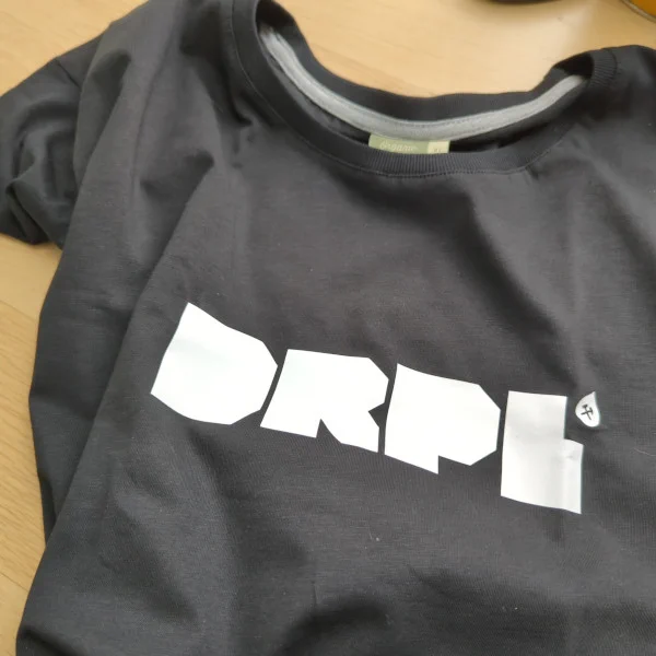 A black t-shirt with white letters DRPL