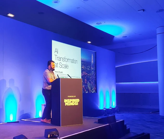 Haris on stage at a lectern 