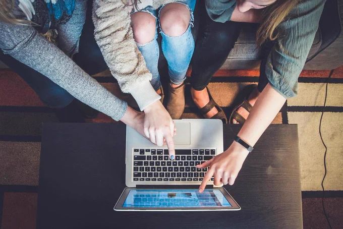 students looking at a laptop