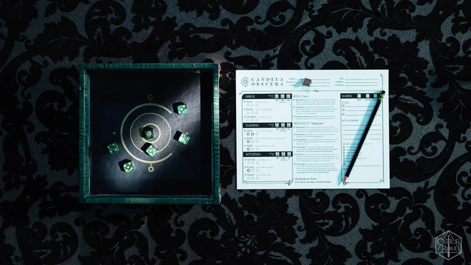 An illuminated dice tray full of Candela Obscura themed dice sit next to a Candela Obscura character sheet against a backdrop of dark green and black paisley in this photo 
