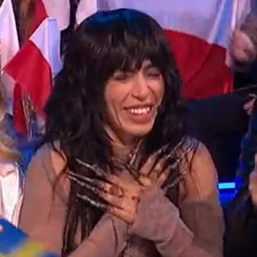 Sweden Eurovision entry with arms crossed against chest showing off her nails