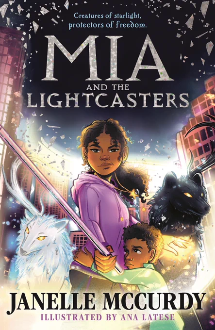 Jacket image with a cityscape in the background and a young girl with curly dark hair and wearing a lilac hoodie in the centre. She holds a staff life glowing weapon while a young boy in a green shirt hugs her waist while two wolves, one white, the other black, flank her.