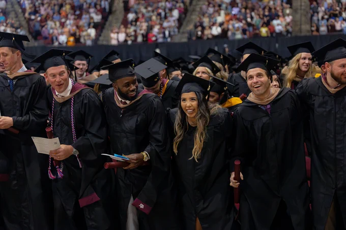Graduates sawing 'em off in the crowd at the end of the ceremony.