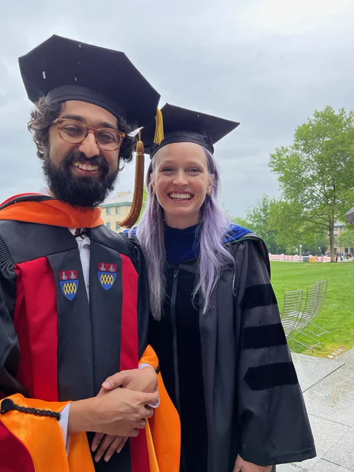 Chinmay and I wearing our regalia smiling in the rain
