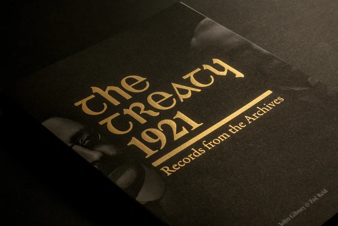 The cover features black-and-white images of two of the lead negotiators David Lloyd George and Arthur Griffith with the title overlaid in gold foil.