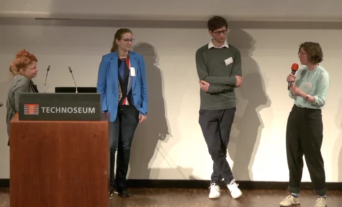 Screenshot: Die vier Vortragenden auf dem Podium des Technoseums im Gespräch.