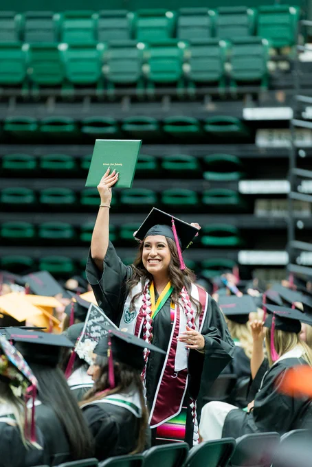 A student proudly holds her diploma cover at the Spring 2023 CSU commencement ceremony.