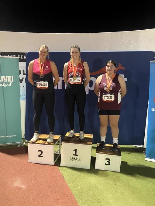 Annabelle Stokes standing on the third place podium after winning bronze in Women's Hammer. 