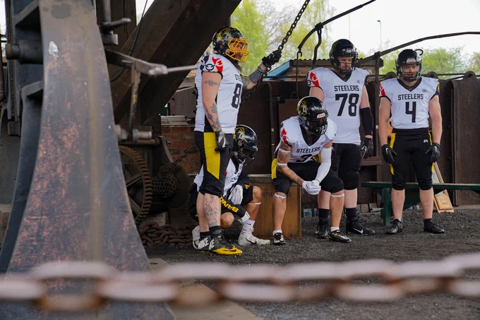 Team of American Football players posing at the Museum 