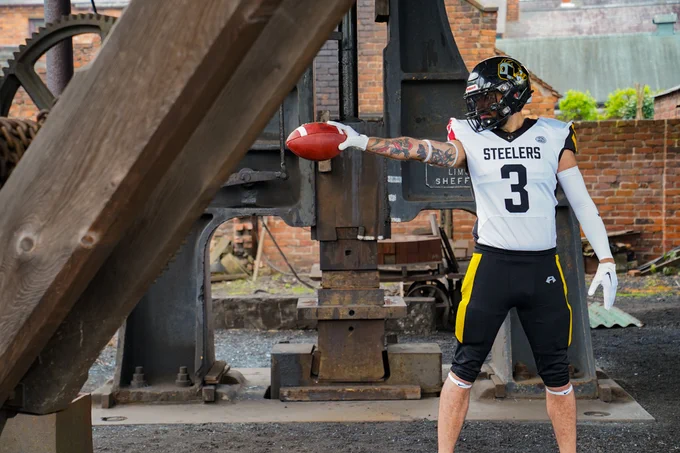American Football player posing with ball at the Museum 