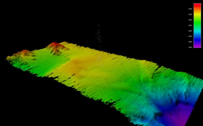 Three-dimensional-modeled multibeam bathymetry data with the gas seep bubbles detected near the Aleutian Trench depicted as pixels extending from the middle of the model. 3D model produced by Amanda Bittinger, Sunset Hydrographics.