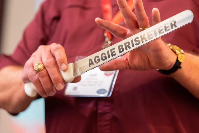 An Aggie showing off their Aggie Brisketeer knife