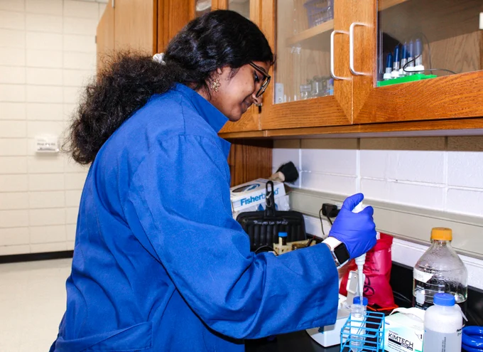 Sreehitha “Siri” Anugu uses tools in a biology lab.