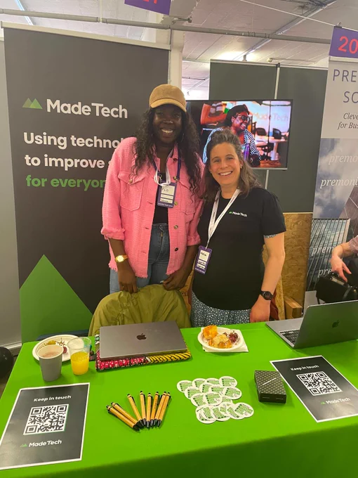 Members of the Made Tech team at our event stand with branded swag ready to give out.