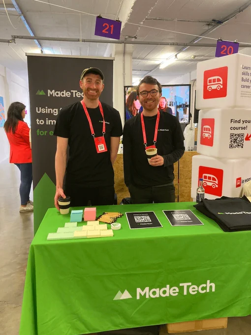 Members of the Made Tech team at our event stand with branded swag ready to give out.