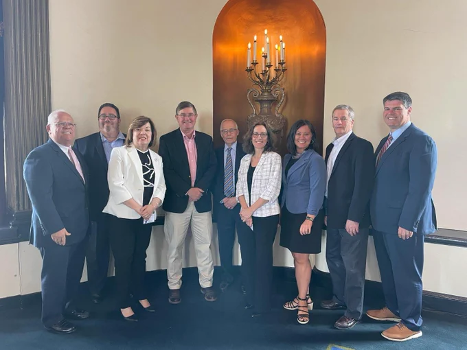 Photo of a group of people.  From Left to Right: Mark S. Hayward, SBA, Cliff Paredes, MA SBDC, Diane Fournaris, RI SBDC, Tee Rowe, ASBDC, Joe Ercolano, CT SBDC, Linda Rossi, VT SBDC, Liz Gray, NH SBDC, Mark Delisle, Maine SBDC and Mike Vlacich, SBA. 